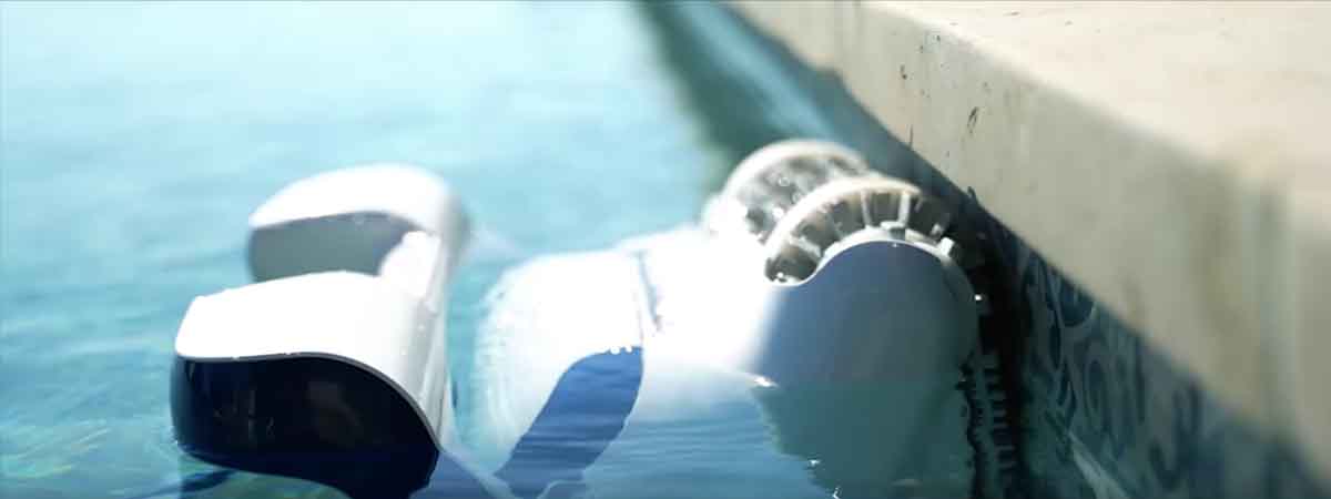 Robotic pool cleaner cleaning the waterline of a large pool